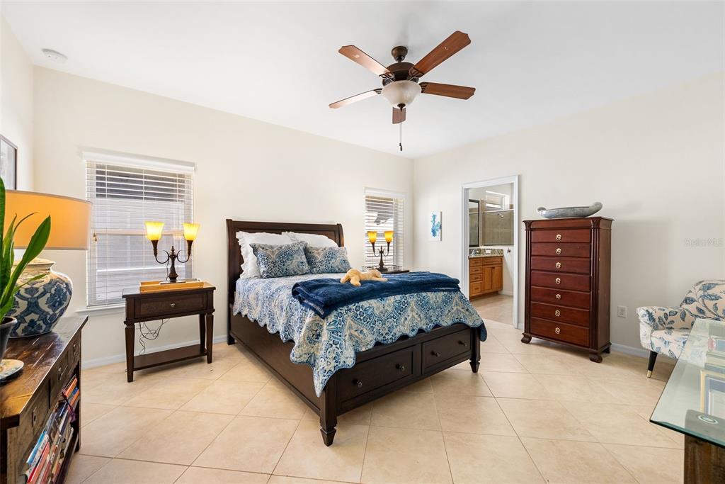 7638 Southwest 80th Drive Gainesville, FL 32608 - Photo 23 of 48 a bedroom with a bed and a chandelier