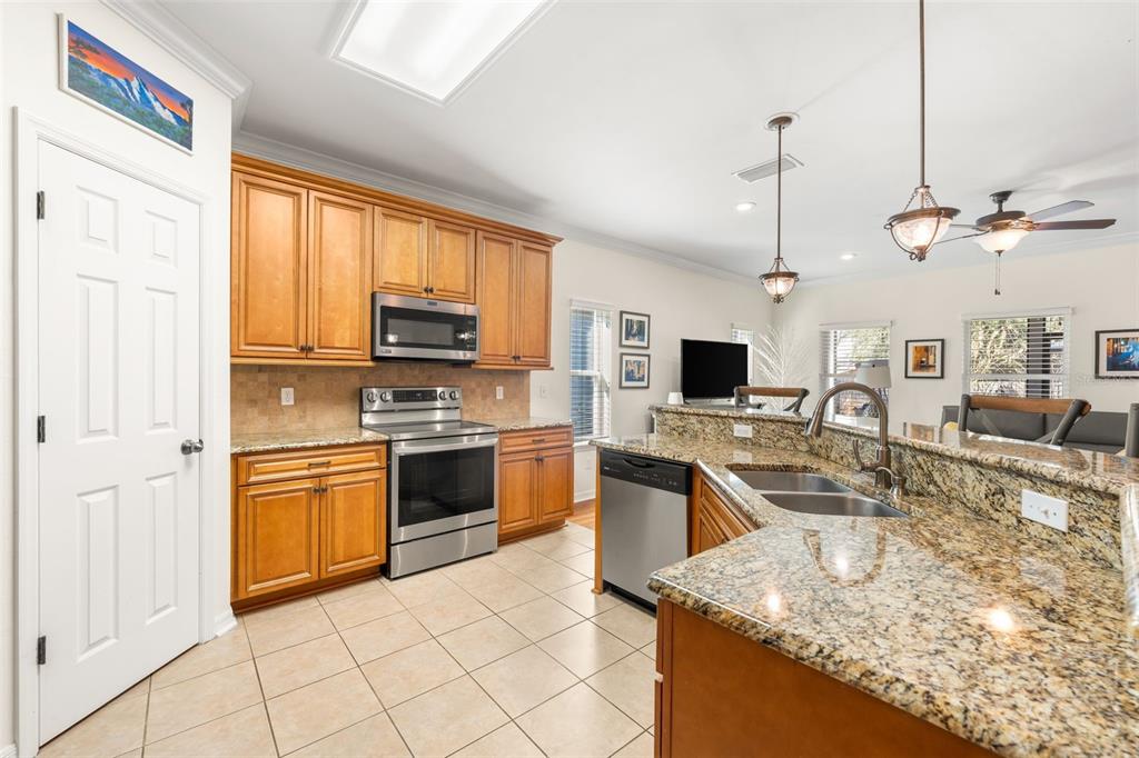 7638 Southwest 80th Drive Gainesville, FL 32608 - Photo 10 of 48 a kitchen with stainless steel appliances granite countertop a sink stove and refrigerator
