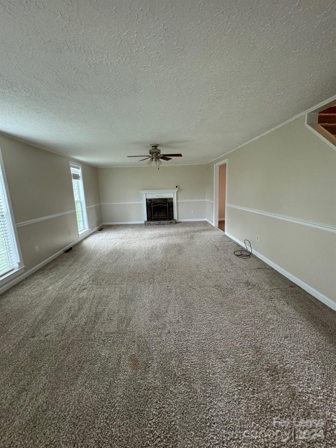 2793 Highway 268 Lenoir, NC 28645 - Photo 16 of 29 a view of an empty room with a fireplace and a window