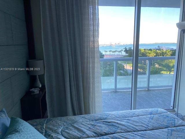 50 Biscayne Boulevard, Unit 709 Miami, FL 33132 - Photo 12 of 18 a bedroom with a bed and balcony view