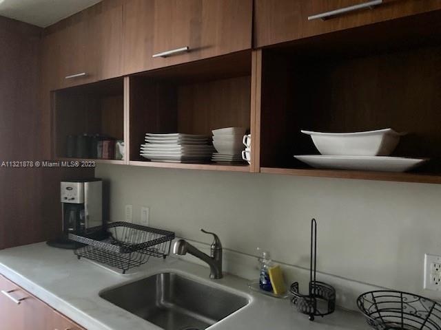 50 Biscayne Boulevard, Unit 709 Miami, FL 33132 - Photo 17 of 18 a kitchen with a sink and a stove top oven