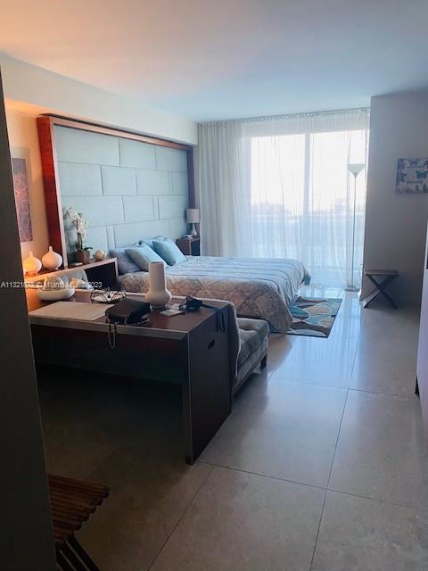 50 Biscayne Boulevard, Unit 709 Miami, FL 33132 - Photo 2 of 18 a bed sitting in a bedroom next to a window