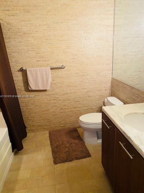 50 Biscayne Boulevard, Unit 709 Miami, FL 33132 - Photo 3 of 18 a bathroom with a granite countertop toilet and a sink