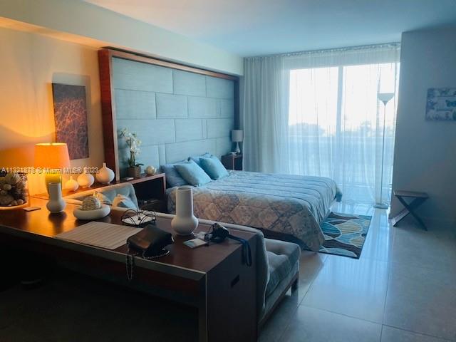 50 Biscayne Boulevard, Unit 709 Miami, FL 33132 - Photo 10 of 18 a bedroom with a bed and a window