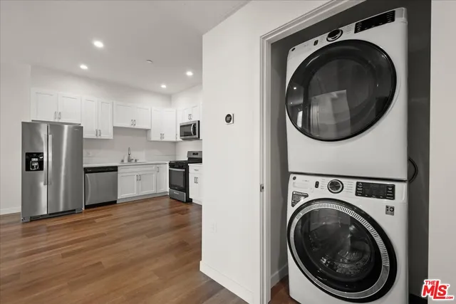 a view of a kitchen with stainless steel appliances washer and dryer