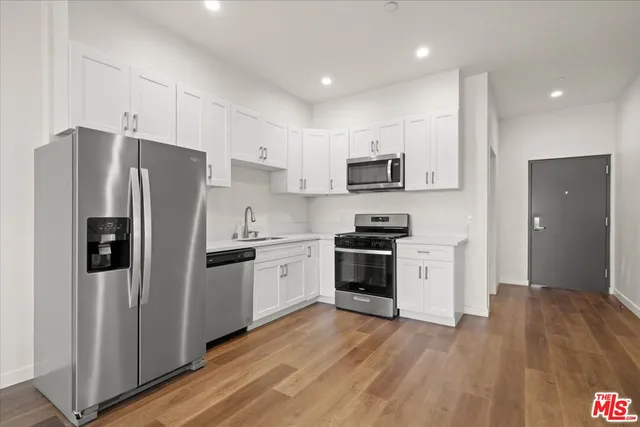 a kitchen with stainless steel appliances a refrigerator stove microwave and sink