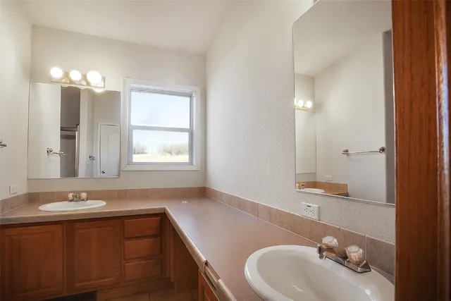 a bathroom with a sink a toilet and mirror