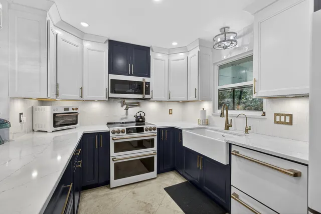 a living room with furniture a flat screen tv and kitchen view