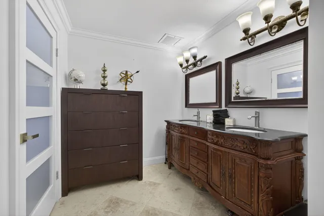 a bedroom with a bed and a flat tv screen on dresser