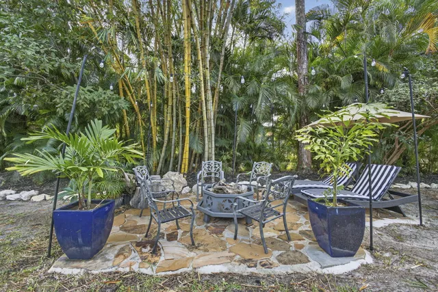 an aerial view of a house with a yard and lake view