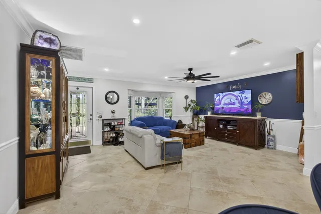 a living room with furniture and a view of kitchen