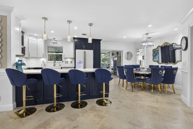 a view of a dining room with furniture a chandelier and wooden floor
