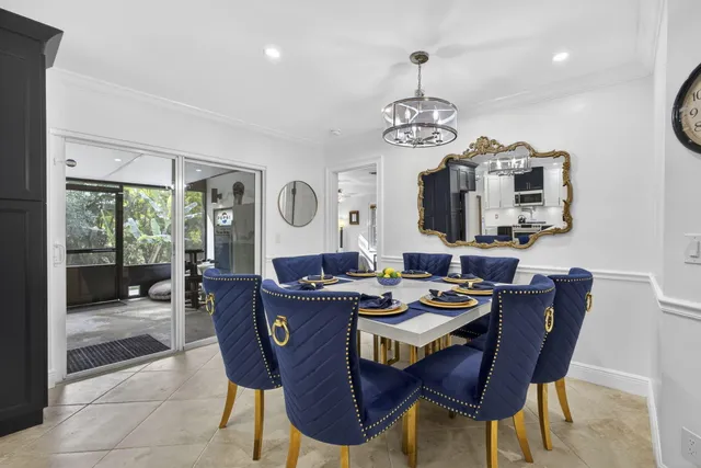 a kitchen with stainless steel appliances granite countertop a stove top oven a sink dishwasher and a refrigerator with wooden floor