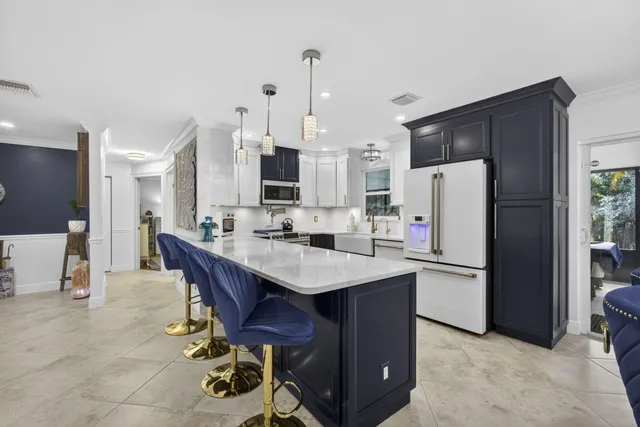 a kitchen with a sink a stove and refrigerator