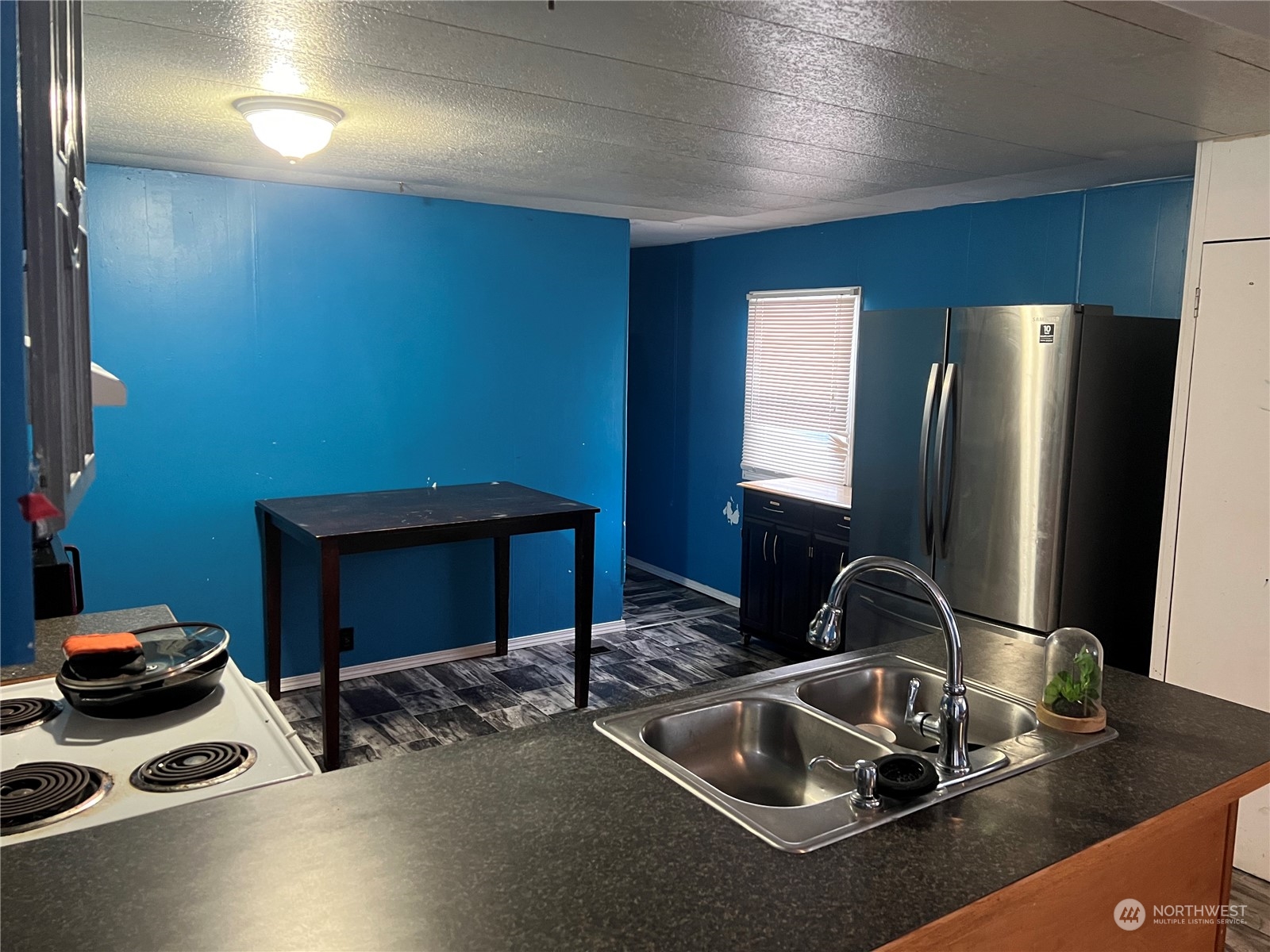 1331 West Pine Street, Unit 34 Walla Walla, WA 99362 - Photo 6 of 10 a kitchen with a sink and a refrigerator