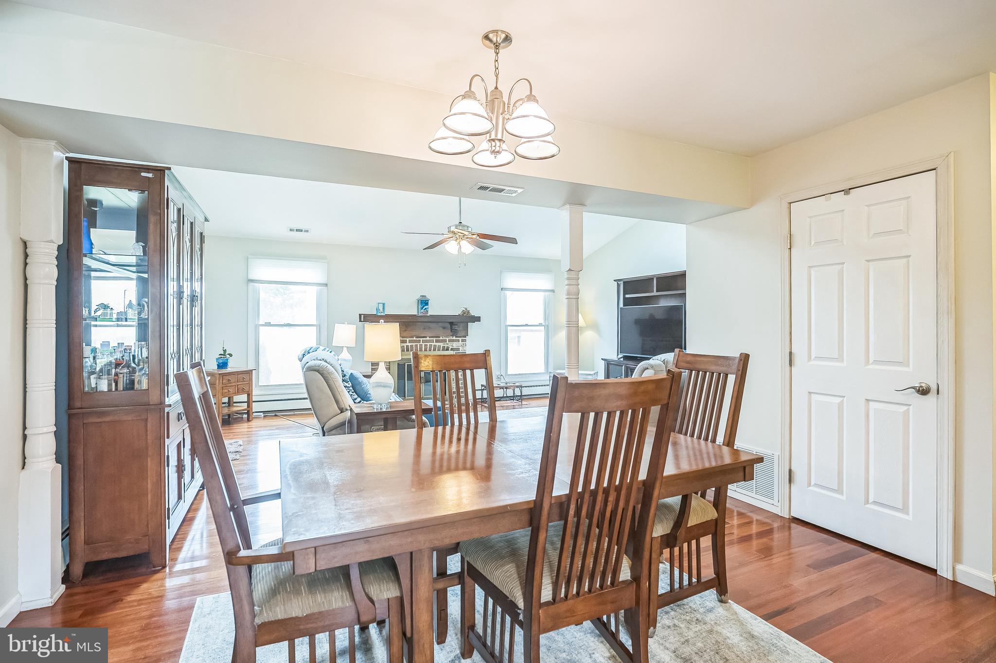 45 Dover Road Westampton, NJ 08060 - Photo 14 of 38 a dining room with wooden floor a chandelier a wooden table and chairs