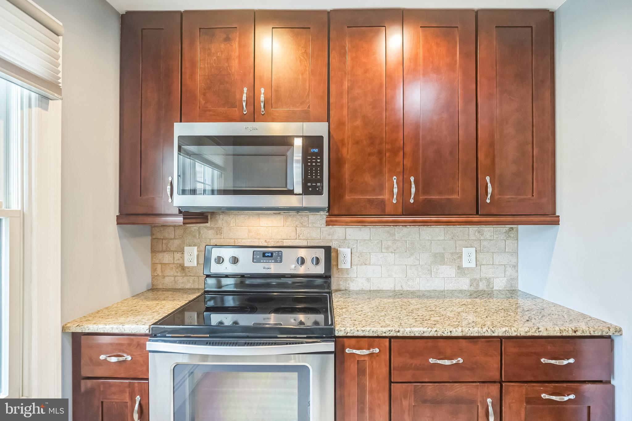 45 Dover Road Westampton, NJ 08060 - Photo 19 of 38 a kitchen with granite countertop wood cabinets and a stove top oven