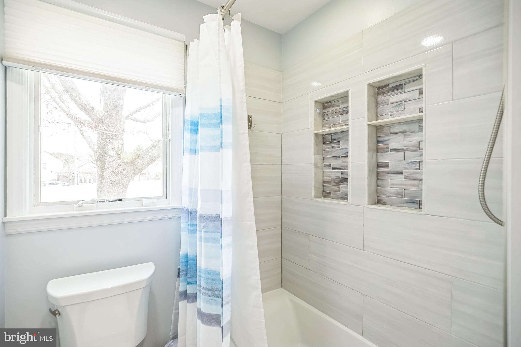 45 Dover Road Westampton, NJ 08060 - Photo 21 of 38 a bathroom with a shower a toilet and a window