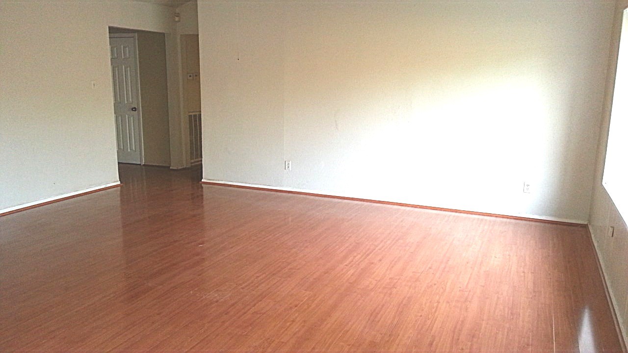 15829 Ridgeroe Lane Houston, TX 77053 - Photo 5 of 15 an empty room with wooden floor and windows