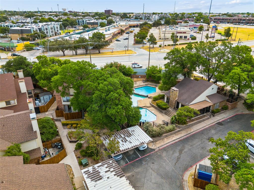 11311 Audelia Road, Unit 102 Dallas, TX 75243 - Photo 29 of 31 Community swimming pools with adjacent clubhouse structure