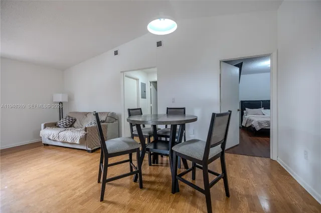 a view of a dining room with furniture and wooden floor