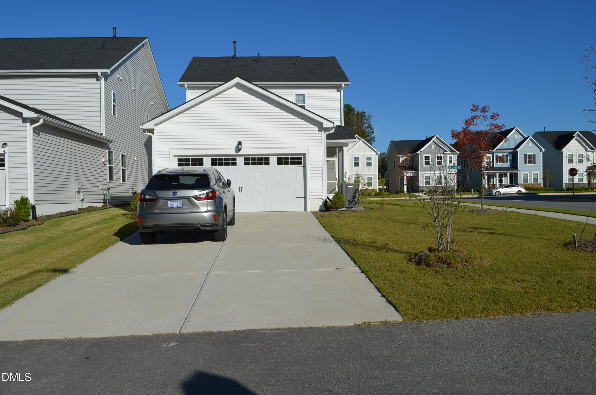 a car parked in front of white house