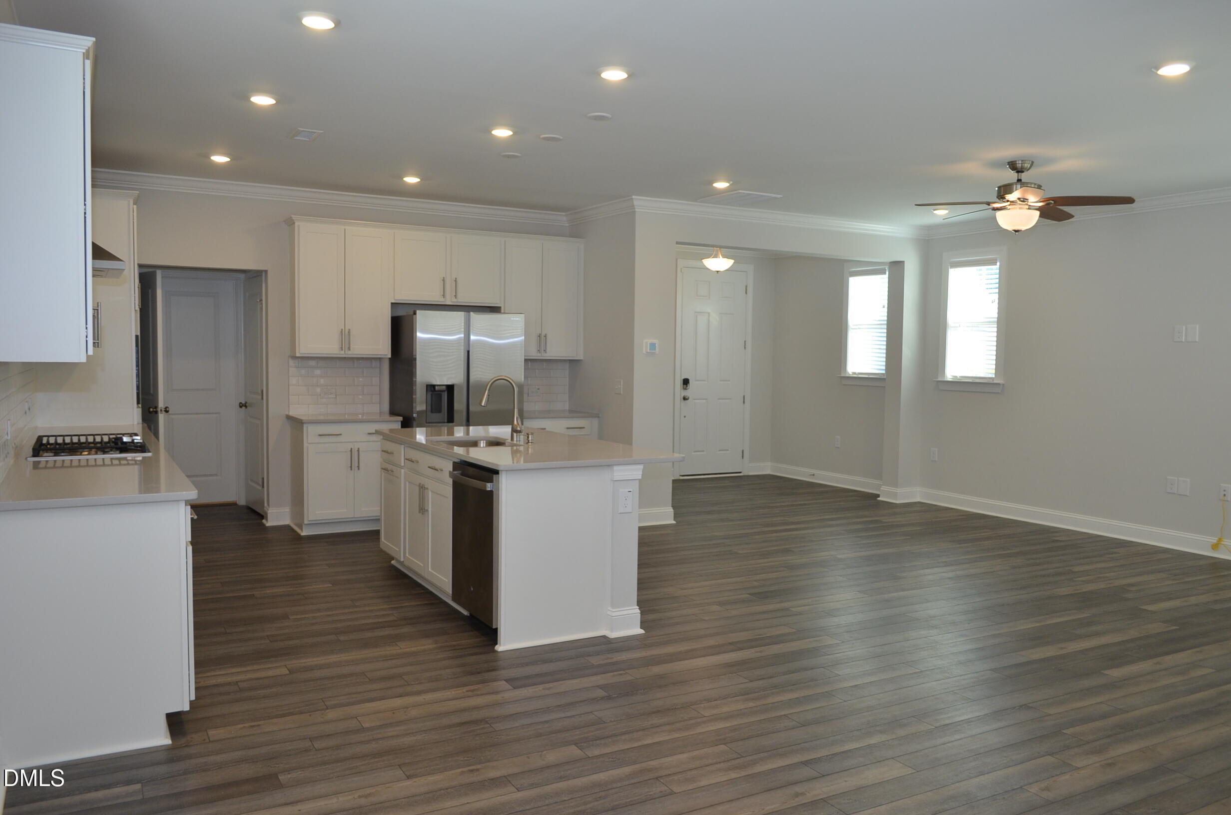 268 Edge Of Auburn Boulevard Raleigh, NC 27610 - Photo 12 of 36 a kitchen with stainless steel appliances a white stove top oven a sink dishwasher and a refrigerator with wooden floor