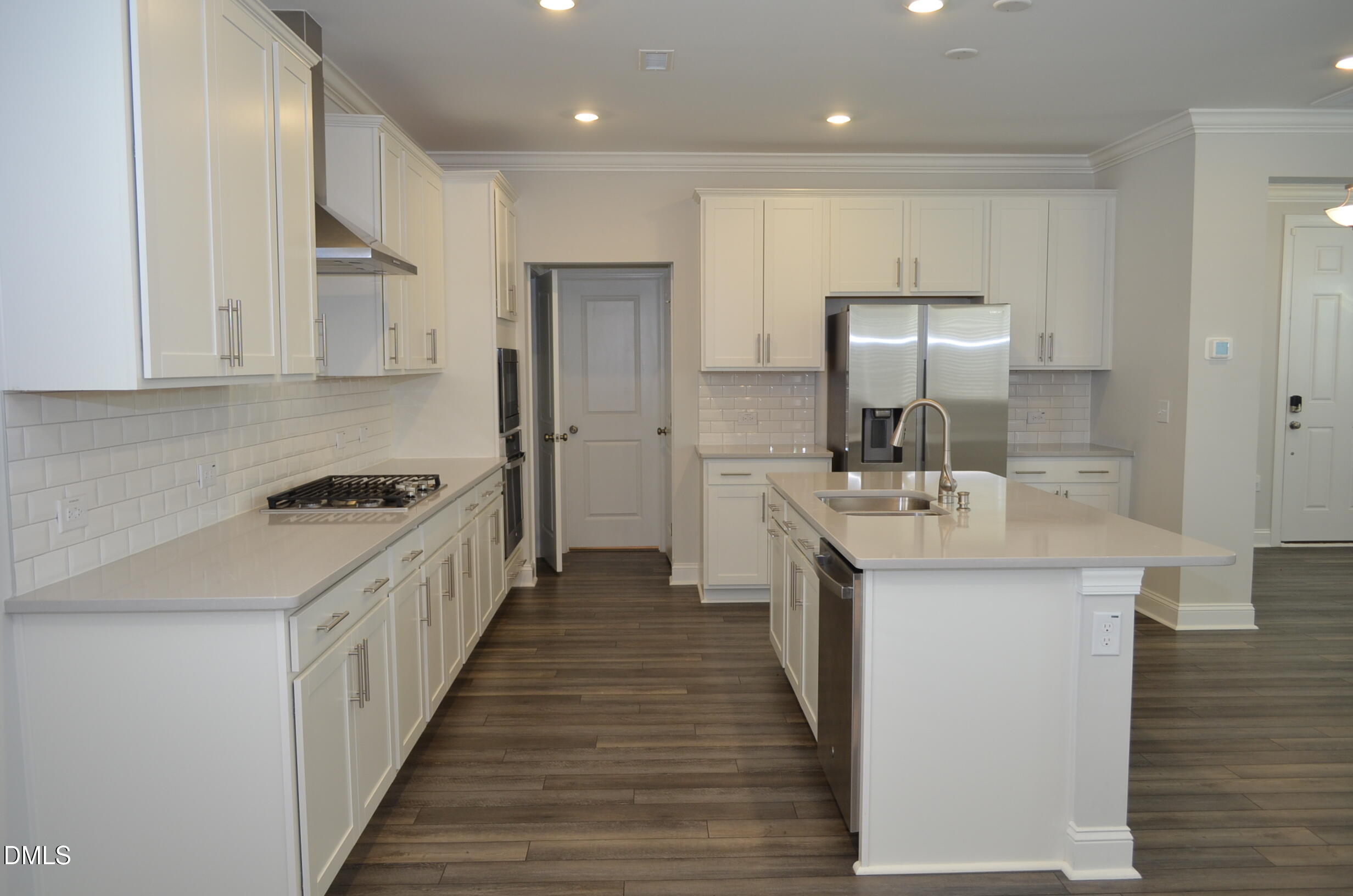 268 Edge Of Auburn Boulevard Raleigh, NC 27610 - Photo 13 of 36 a kitchen with stainless steel appliances a sink stove and cabinets
