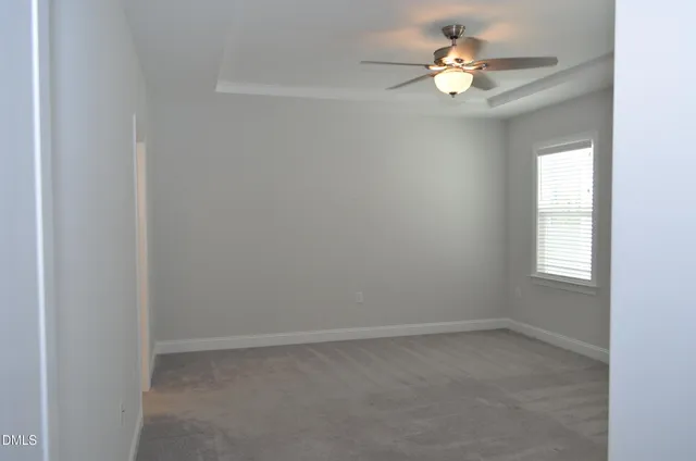 an empty room with closet and a window