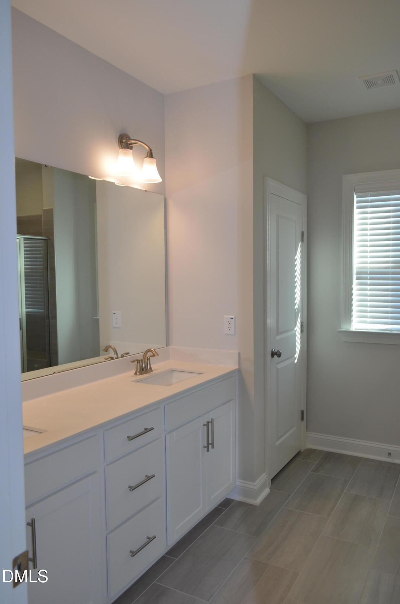 268 Edge Of Auburn Boulevard Raleigh, NC 27610 - Photo 30 of 36 a bathroom with a double vanity sink and mirror