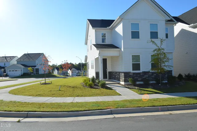 a view of a house with swimming pool and yard
