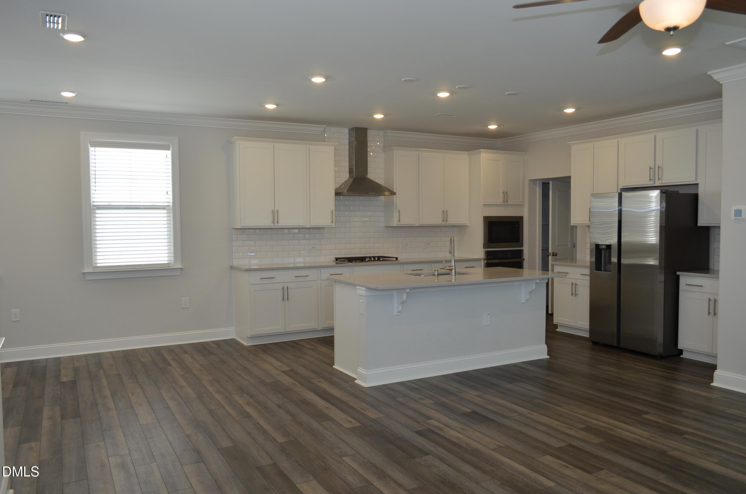 268 Edge Of Auburn Boulevard Raleigh, NC 27610 - Photo 10 of 36 a kitchen with a refrigerator and white cabinets