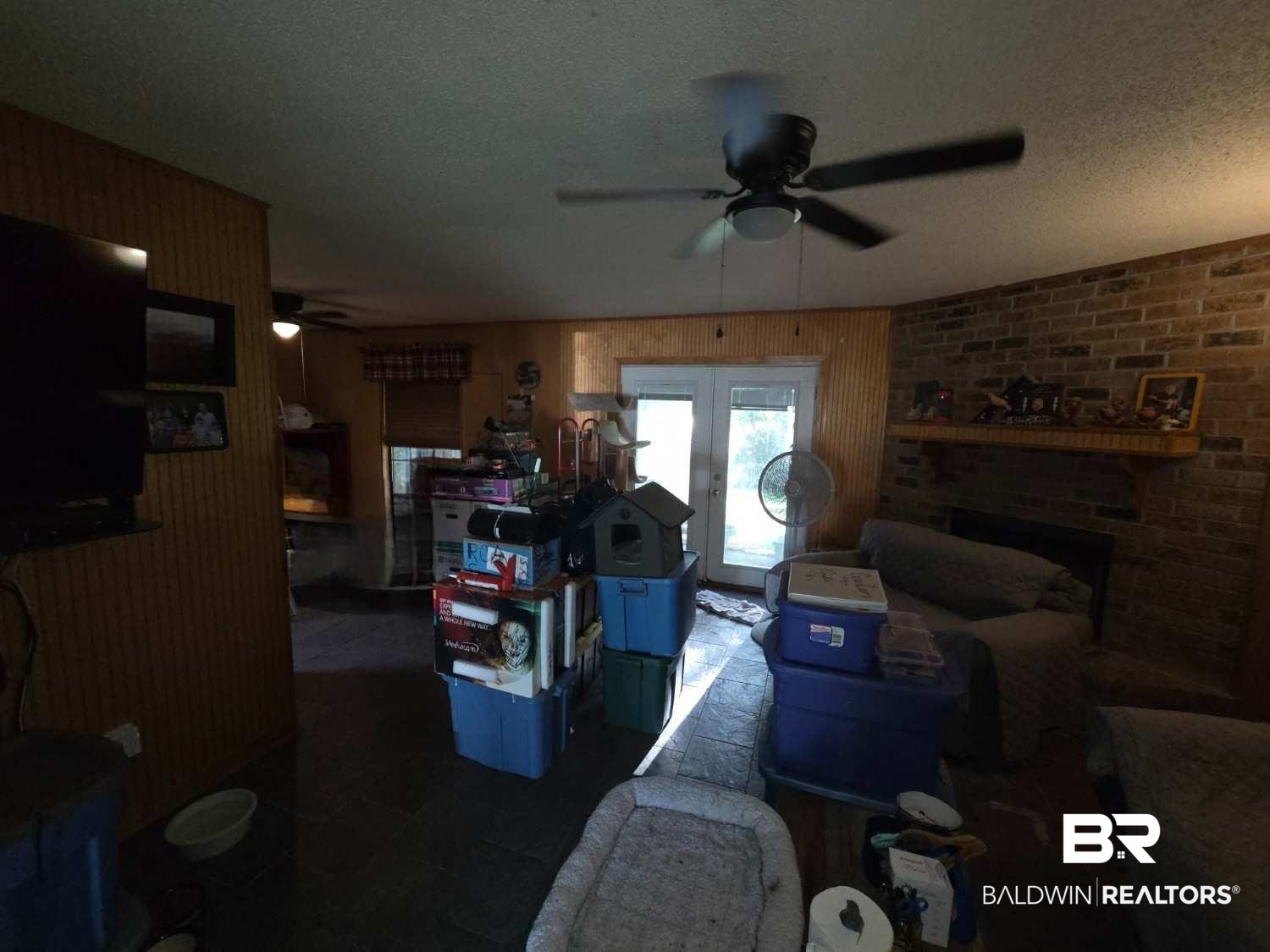 5120 West Celtic Drive Mobile, AL 36619 - Photo 12 of 27 Living room with a fireplace, a textured ceiling, ceiling fan, and wallpapered walls