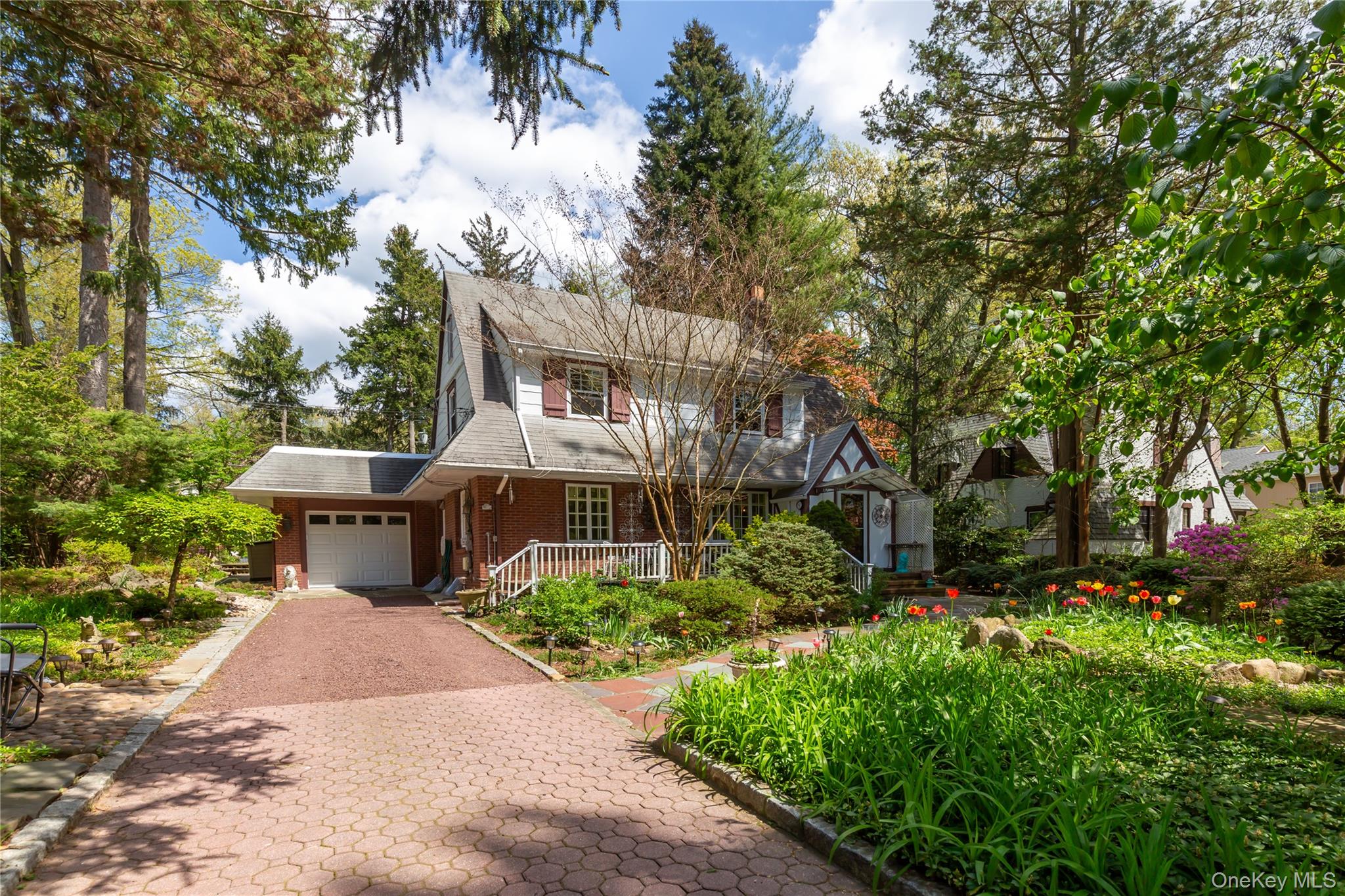 a view of a garden with potted plants and large trees