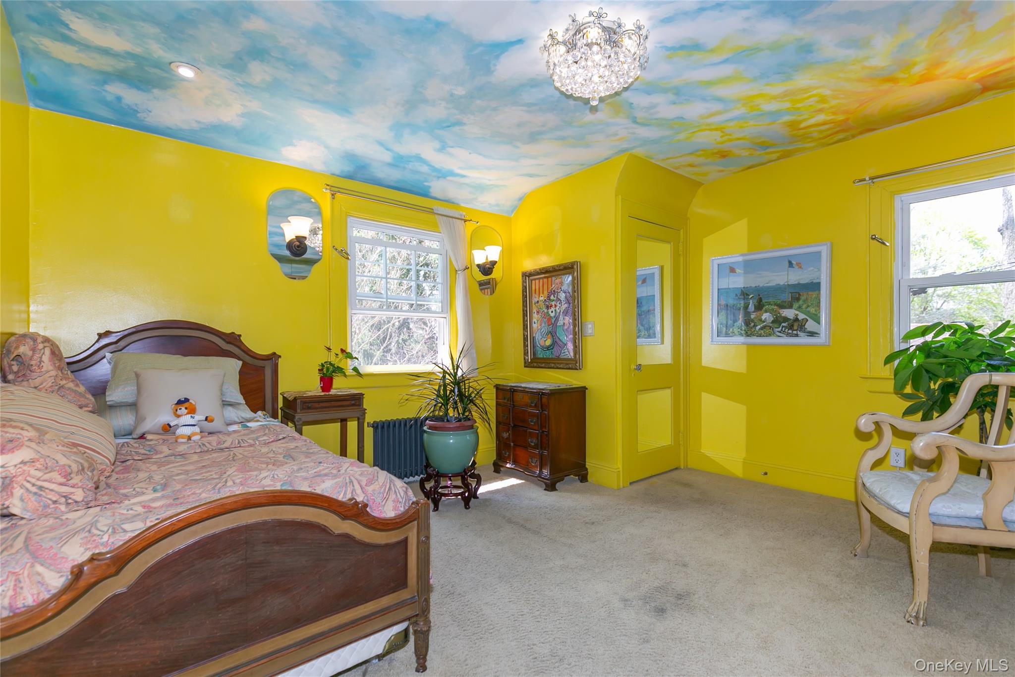 200 Myrtle Drive Great Neck, NY 11021 - Photo 16 of 25 a bedroom with a bed and a chandelier