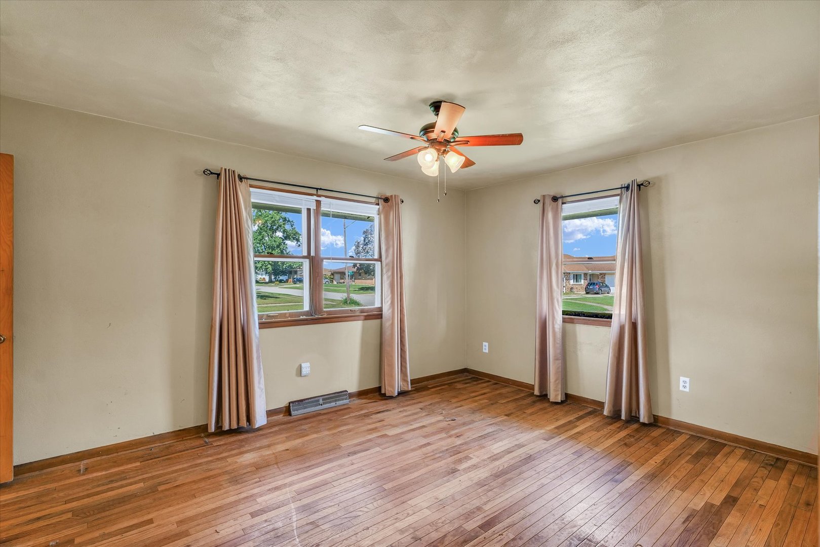 1512 Locust Avenue Rantoul, IL 61866 - Photo 16 of 39 an empty room with wooden floor and windows