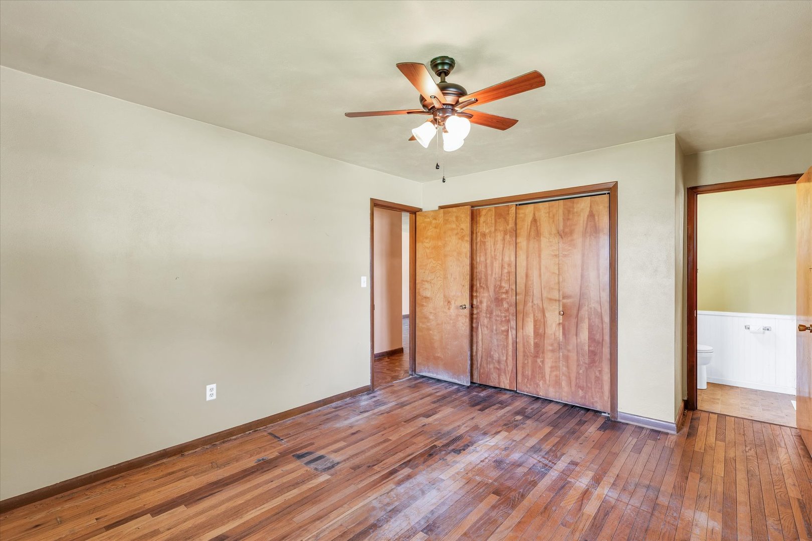 1512 Locust Avenue Rantoul, IL 61866 - Photo 17 of 39 an empty room with wooden floor fan and windows
