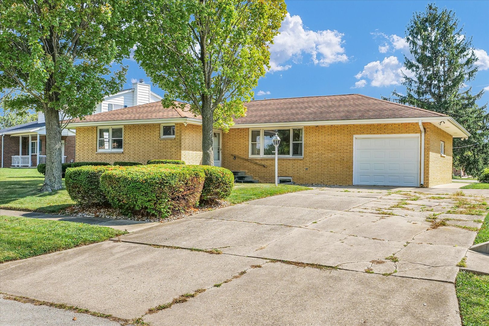 1512 Locust Avenue Rantoul, IL 61866 - Photo 2 of 39 a front view of a house with a garden