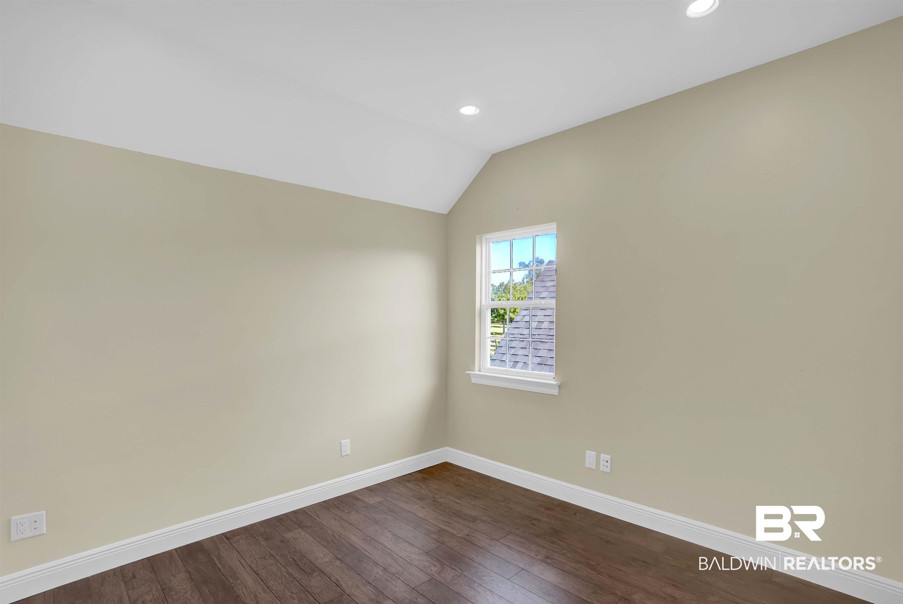 27688 Rigsby Road Daphne, AL 36526 - Photo 42 of 56 Empty room featuring wood-type flooring and vaulted ceiling
