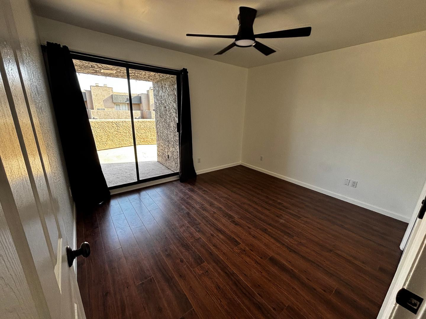 3030 North Hayden Road, Unit 16 Scottsdale, AZ 85251 - Photo 13 of 30 a view of empty room with wooden floor and fan