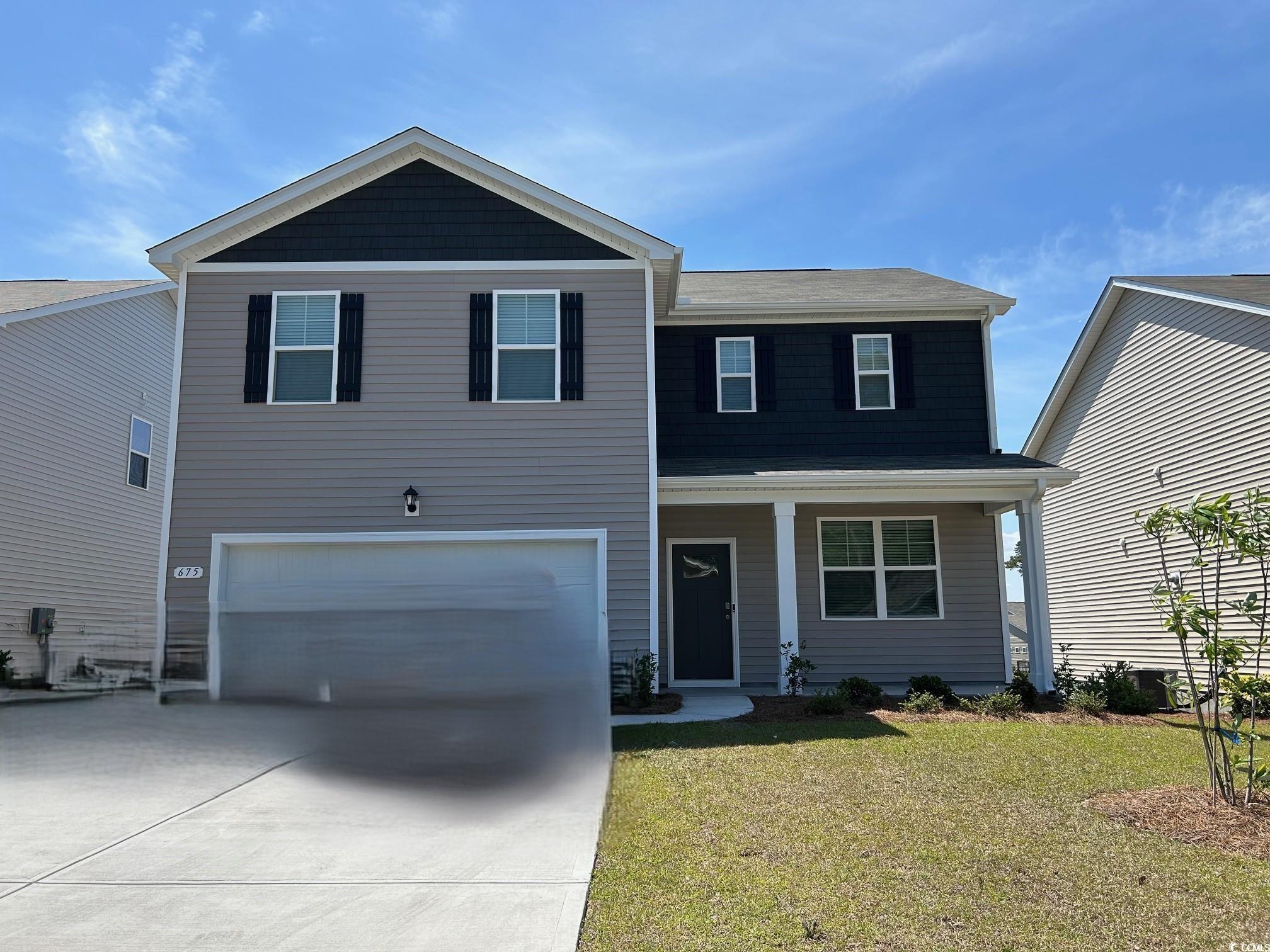 Traditional-style house with an attached garage, c