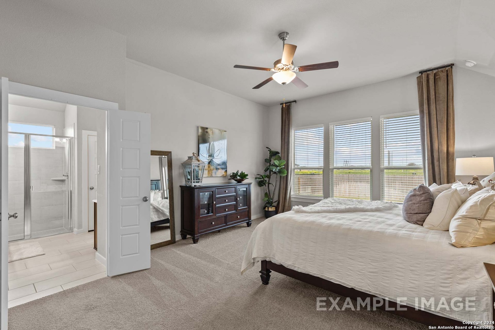 429 Tims Way Seguin, TX 78155 - Photo 31 of 50 a bedroom with a large bed and a chandelier