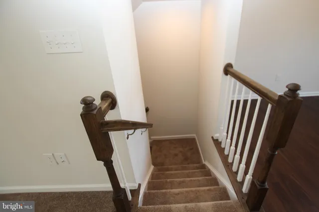 a view of staircase with white walls and stairs
