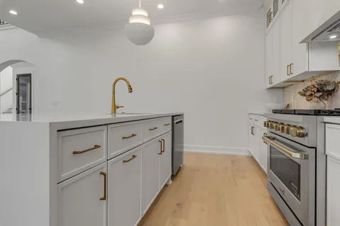 a kitchen with stainless steel appliances white cabinets and a stove