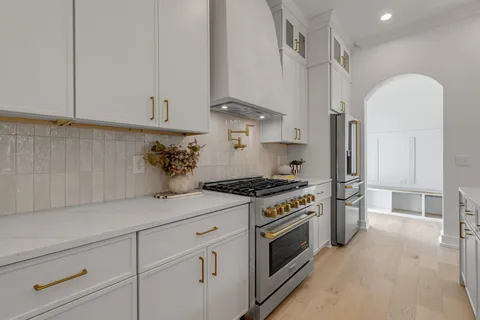 a dining room with furniture and large windows