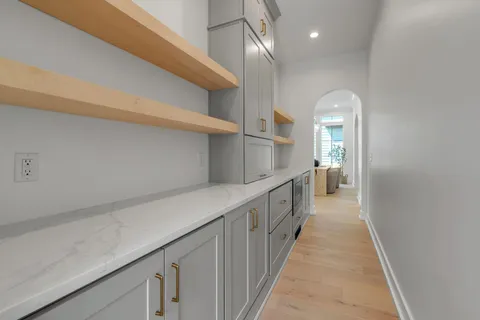 a living room with furniture and chandelier