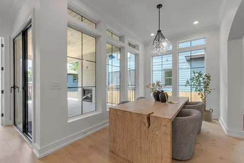 a bed sitting in a bedroom next to a large window