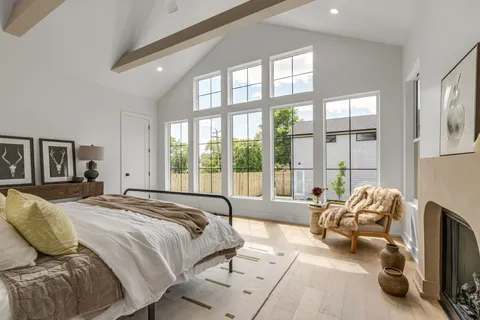 a spacious bedroom with a bed and a large window