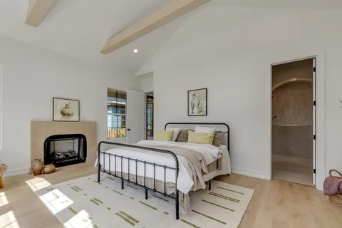 a bedroom with a large bed and a large window