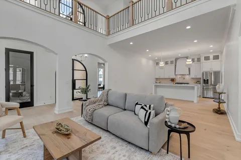 a living room with furniture and a view of kitchen